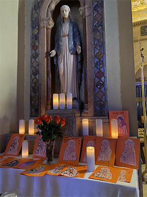 Altar to Mary with candles and drawings